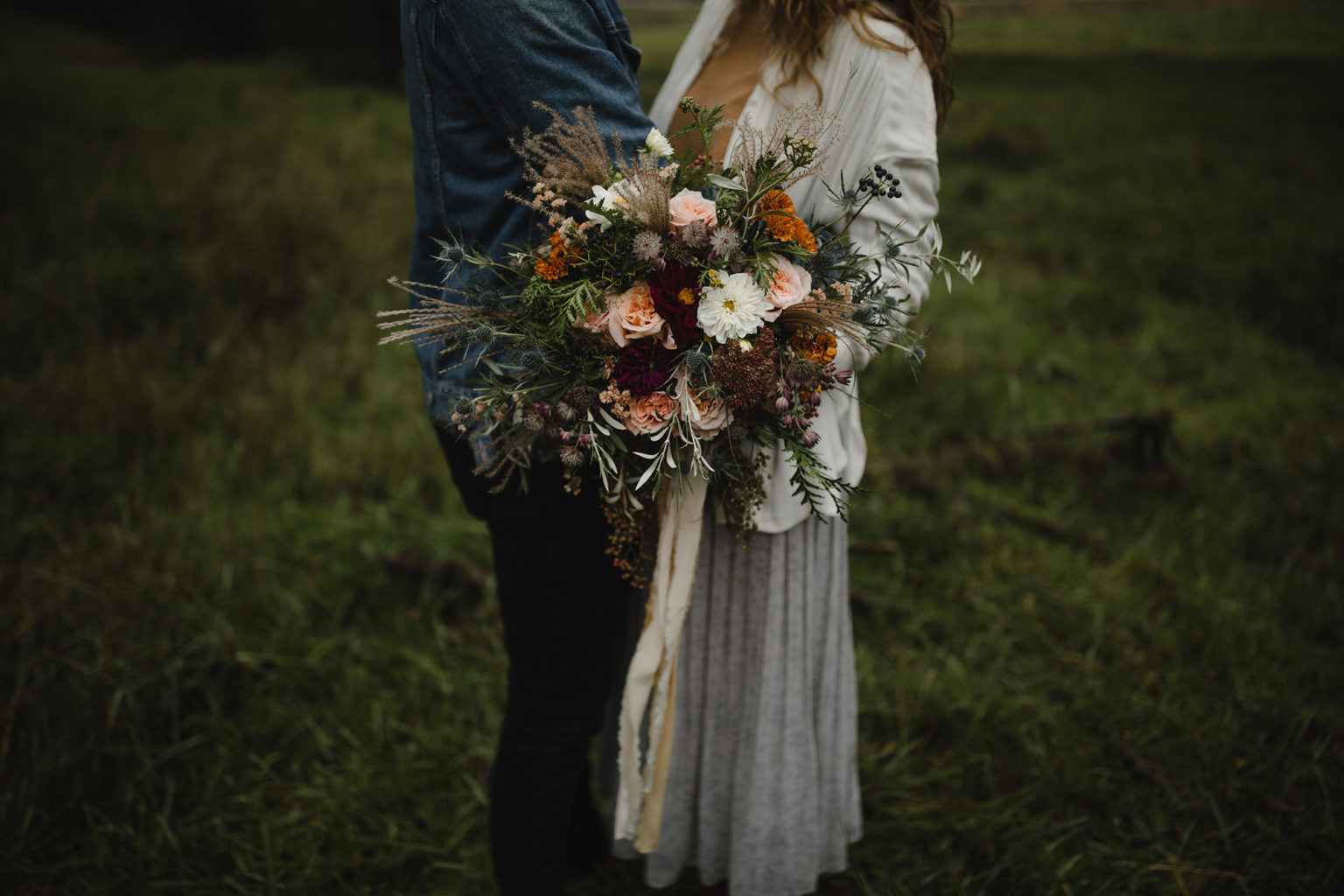 Couple eloping with bride holding bridal bouquet