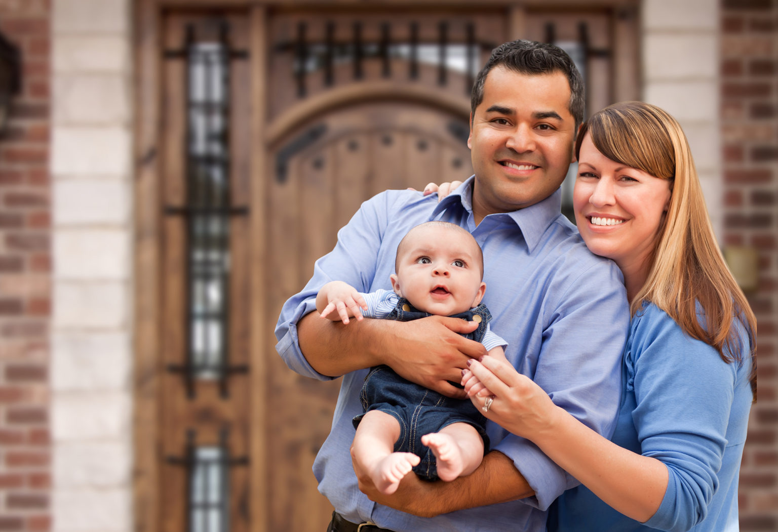 Couple with a new baby smiling