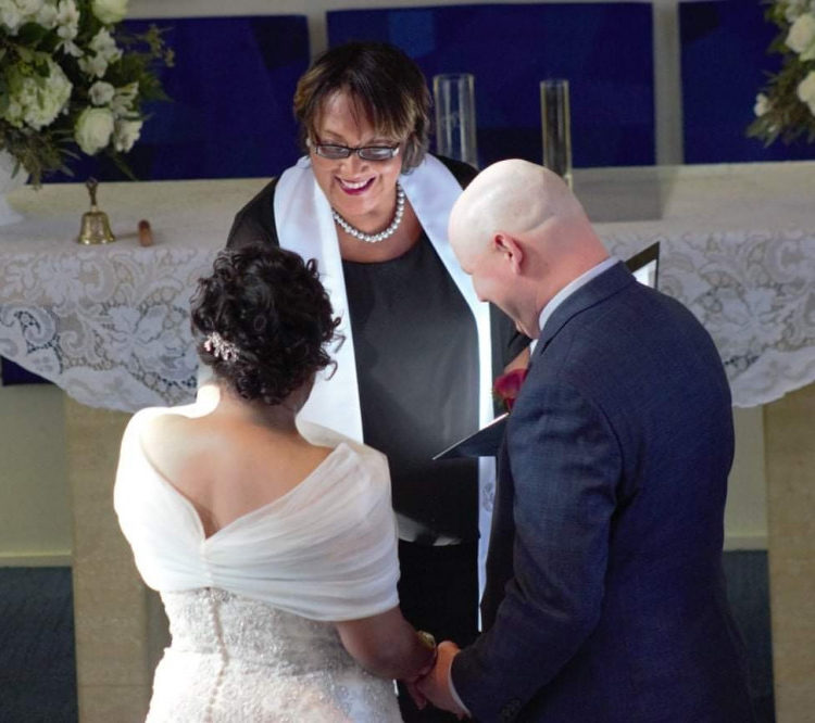 A couple reciting their vows in front of an alter